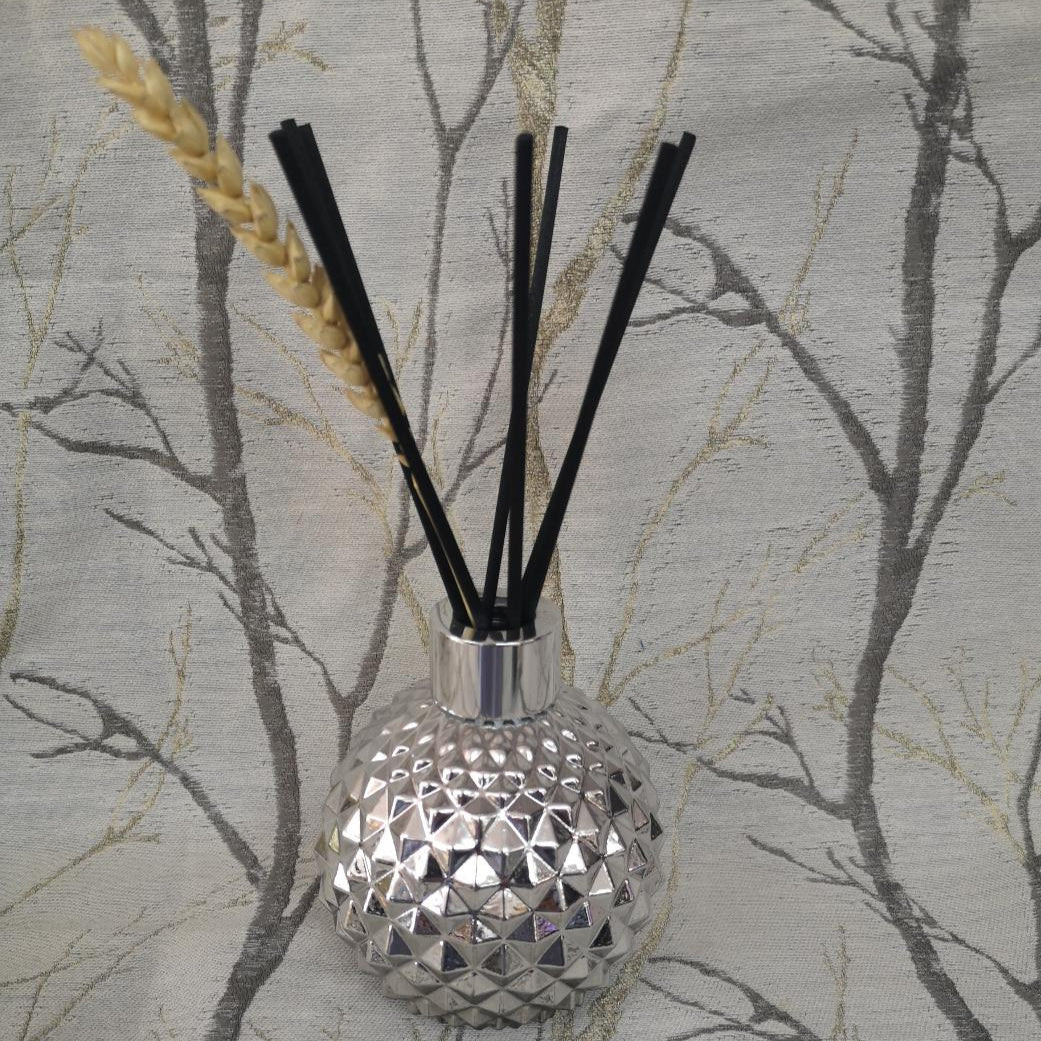 Silver diffuser bottle with black sticks 
